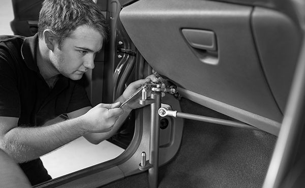 Man performs a check inside a minibus.